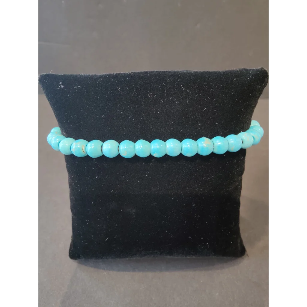 Turquoise beaded stone bracelet with 6mm natural gems on black velvet