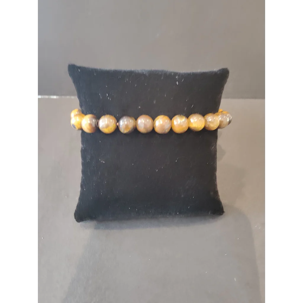 Stunning yellow and brown tiger eye beaded stone bracelet with 8mm beads on black velvet