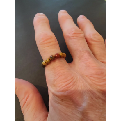 Stunning beaded stone ring in earthy brown, yellow, and red tones