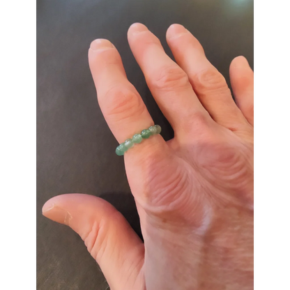 Delicate green jade stone ring on finger from vibrant collection