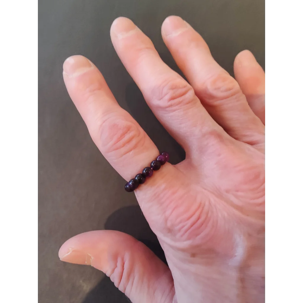 Delicate purple beaded stone ring on finger from vibrant collection