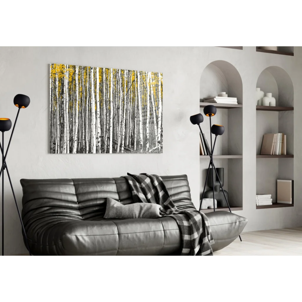 Modern black leather sofa with plaid throw and birch forest wall art