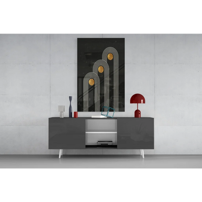 Modern black and white sideboard with sleek legs under geometric wall art print