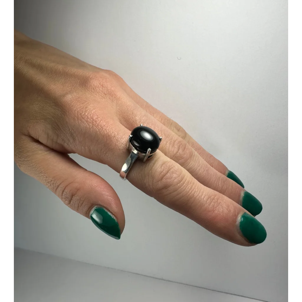 Sleek silver black onyx ring with oval stone in prong setting