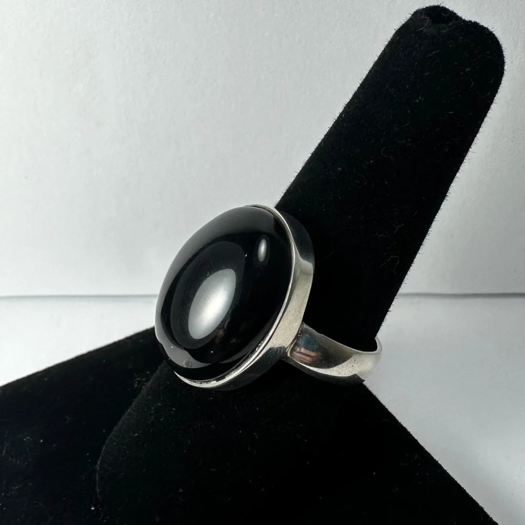 Sleek silver black onyx ring with smooth large stone in minimalist band