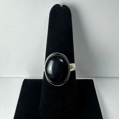 Sleek silver black onyx ring with oval stone in polished bezel