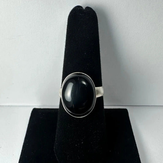 Sleek silver black onyx ring with oval stone in polished bezel