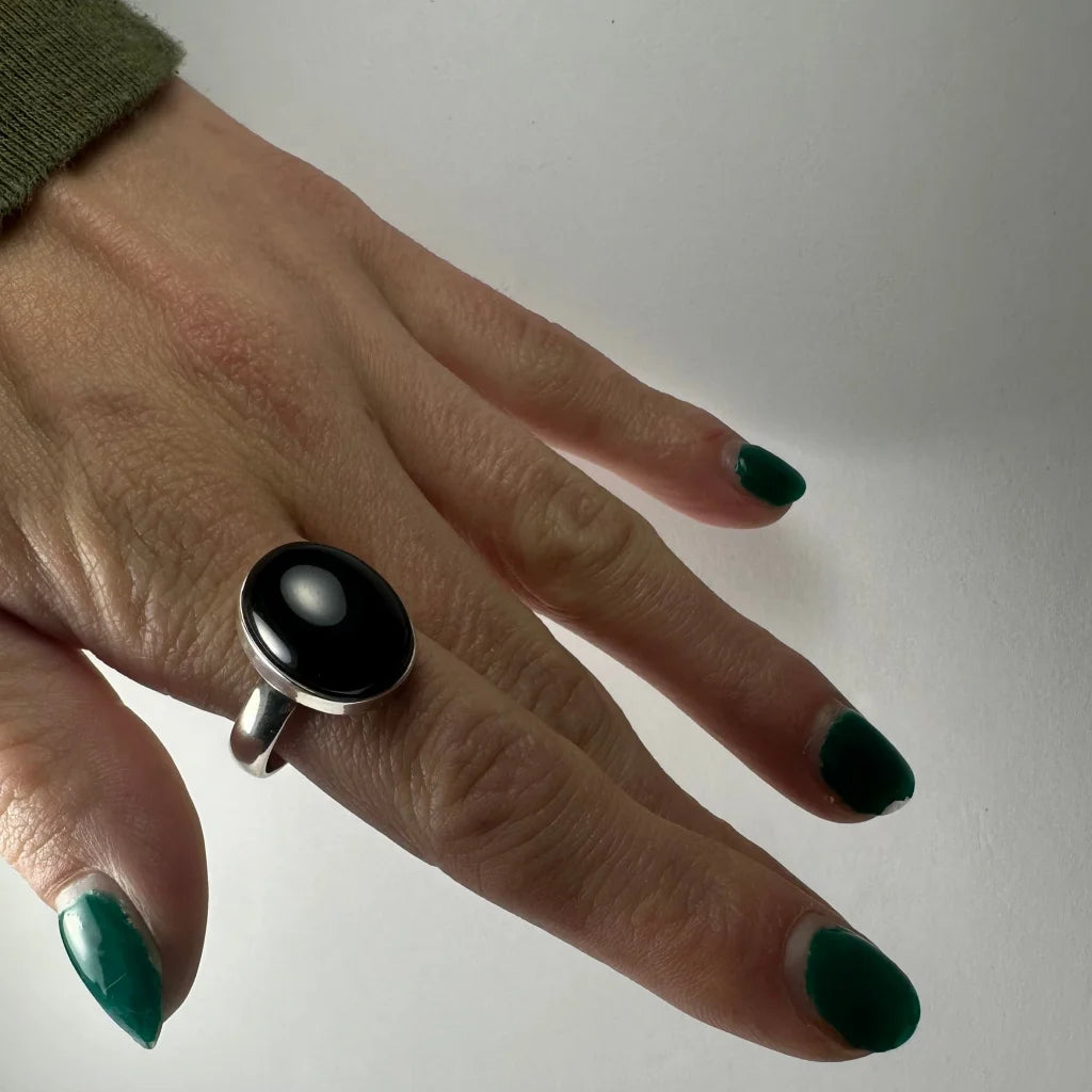 Sleek sterling silver black onyx ring with oval stone and white inlay