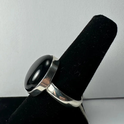 Sleek silver black onyx ring with oval stone in polished band