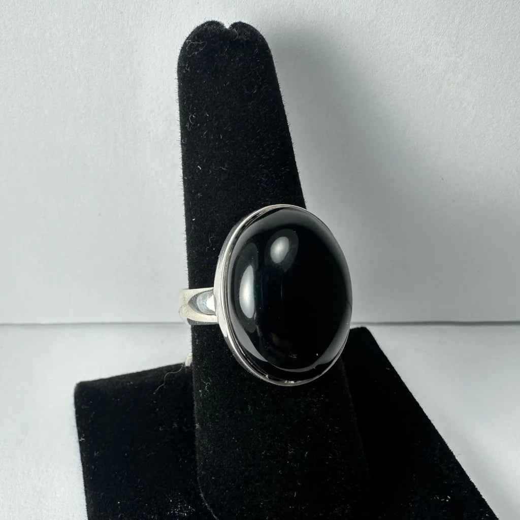Sleek silver black onyx ring with oval bezel-set stone