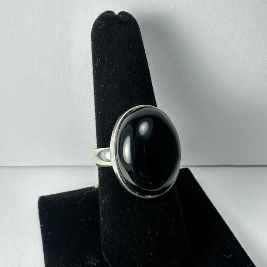 Sleek silver black onyx ring with oval bezel-set stone