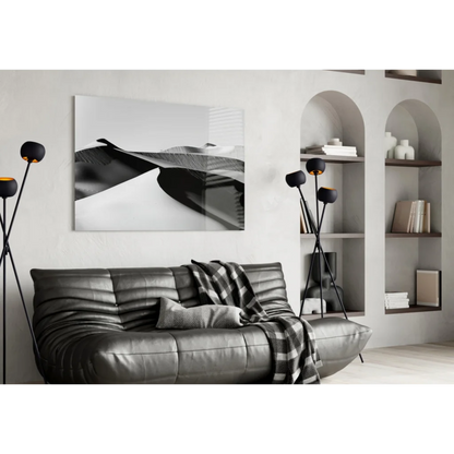 Silver leather sofa with checkered blanket and black white wall art