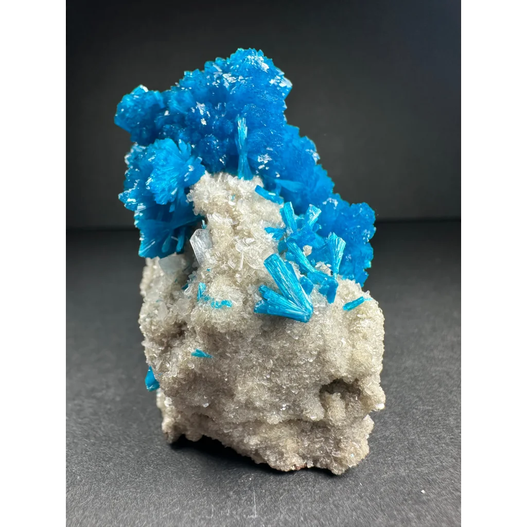 Stunning blue cavansite crystal cluster from India on gray rock