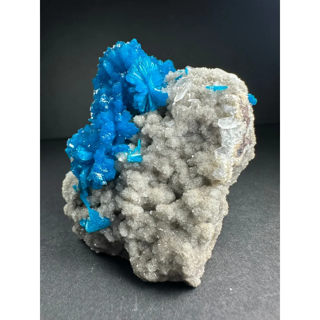 Vibrant blue cavansite crystal cluster on gray rock from India