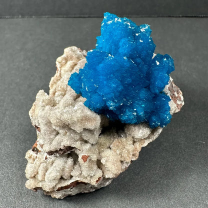 Vibrant blue cavansite crystal cluster on gray rock from India