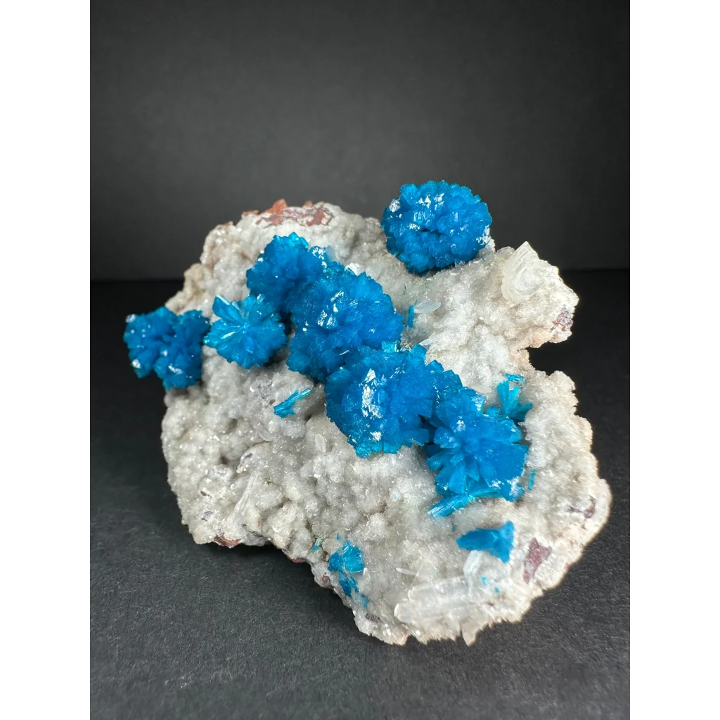 Vibrant blue Cavansite crystal cluster from India on white rock
