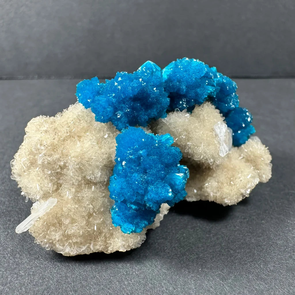 Vibrant blue cavansite crystal cluster on quartz base from India