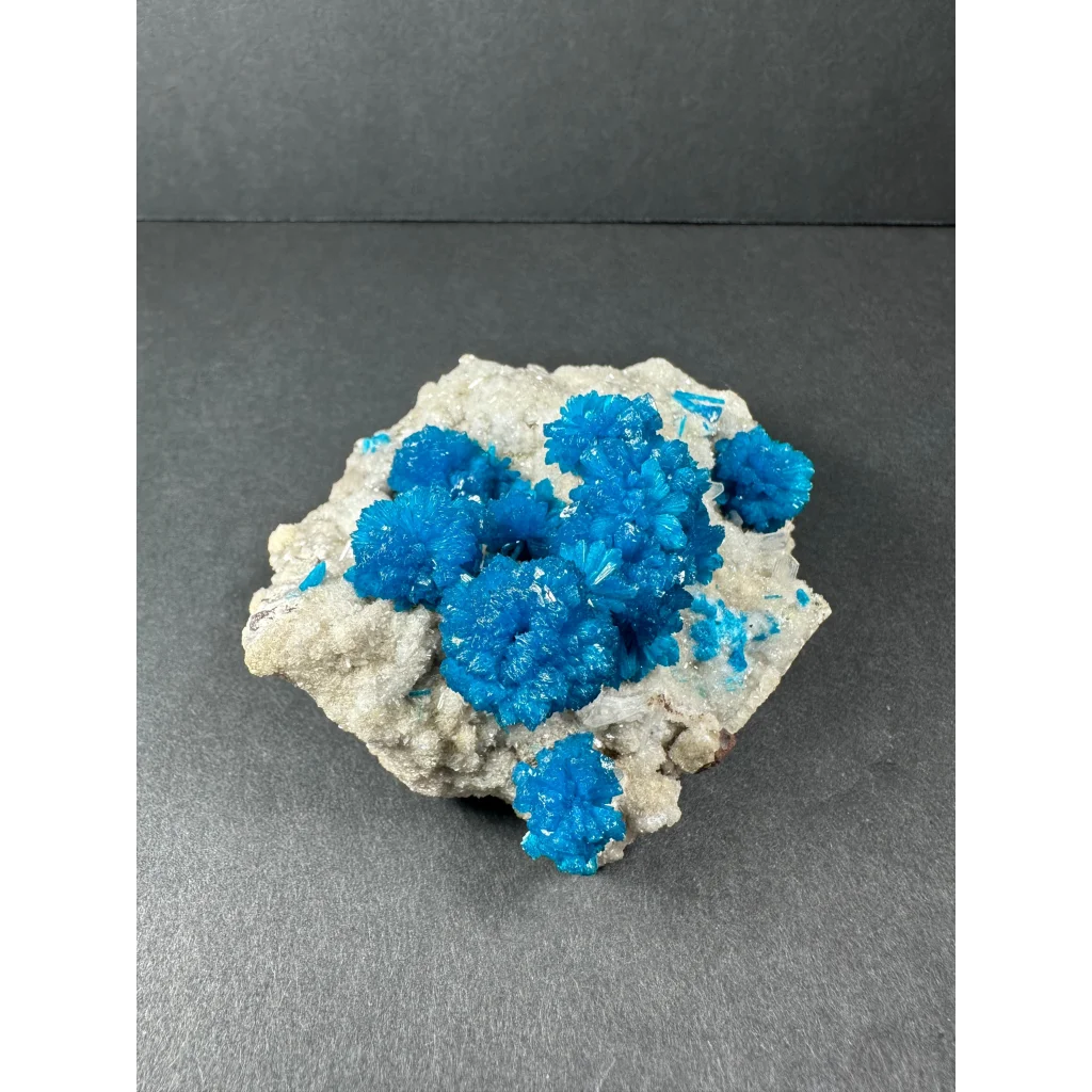 Stunning blue cavansite crystal cluster from India on gray rock