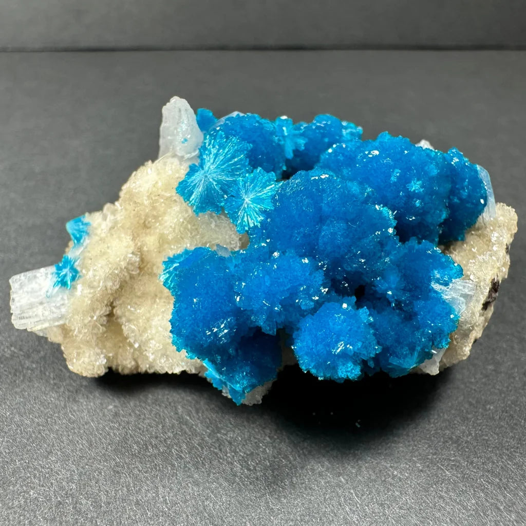 Vibrant blue cavansite crystals on white stilbite matrix