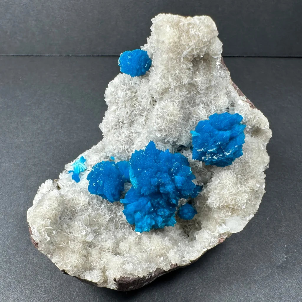 Vibrant blue cavansite crystals on white stilbite matrix Maharashtra