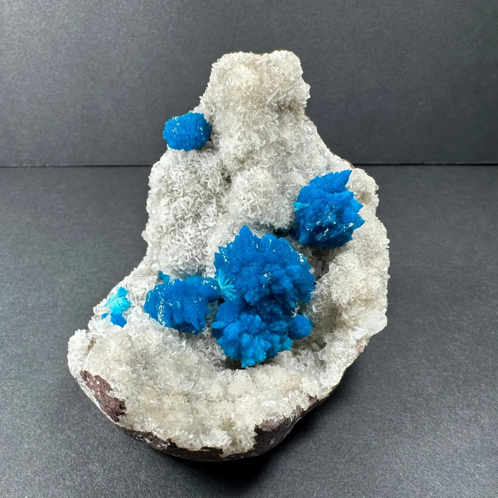 Vibrant blue cavansite crystals on white stilbite matrix Maharashtra