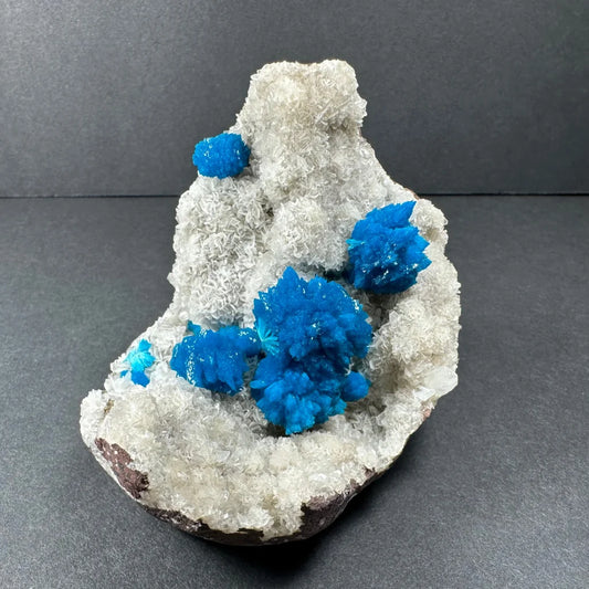 Vibrant blue cavansite crystals on white stilbite matrix Maharashtra