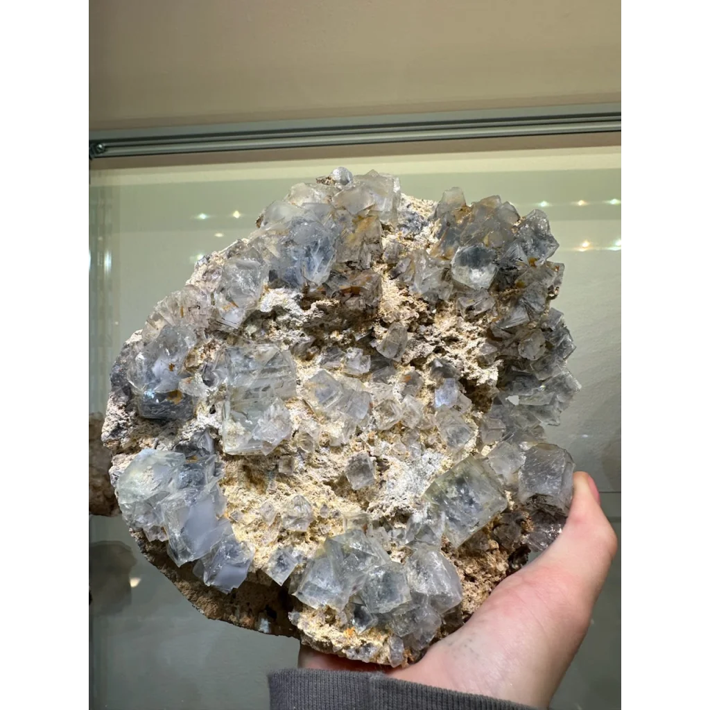 Hand holding stunning blue Fluorite crystal cluster from China
