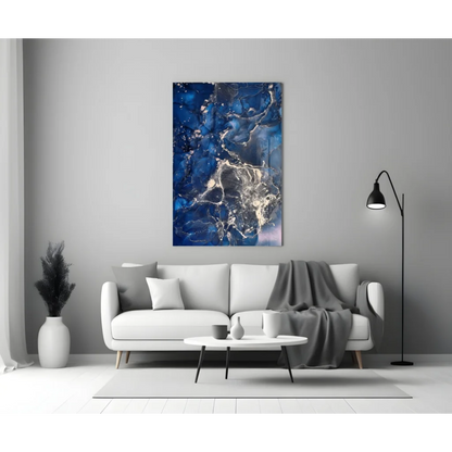 Blue and white swirling glass wall art above sofa