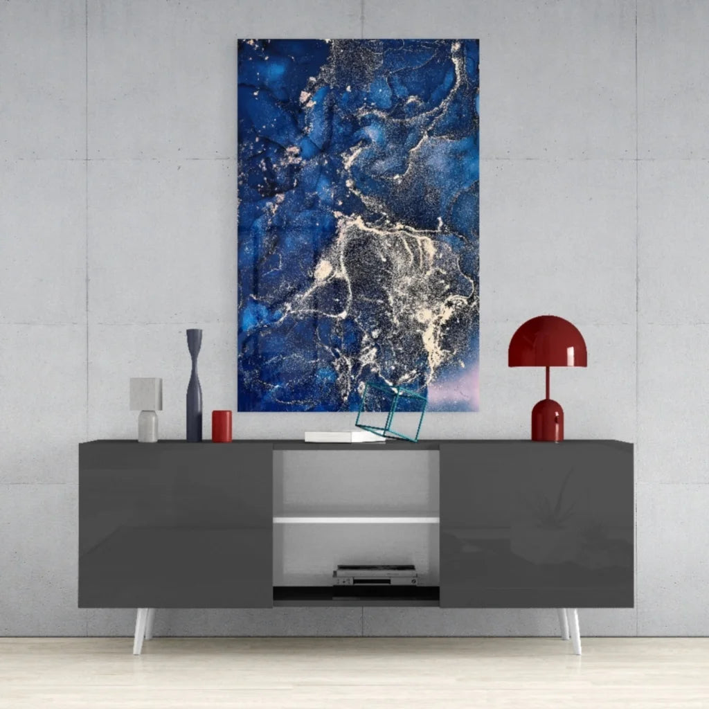 Stunning blue swirl glass wall art with deep blues and gold accents above gray console