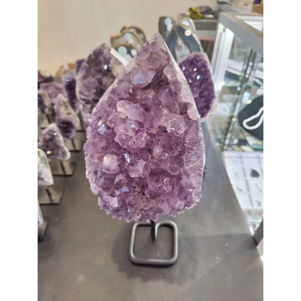 Stunning Brazilian amethyst crystal geode with metal stand