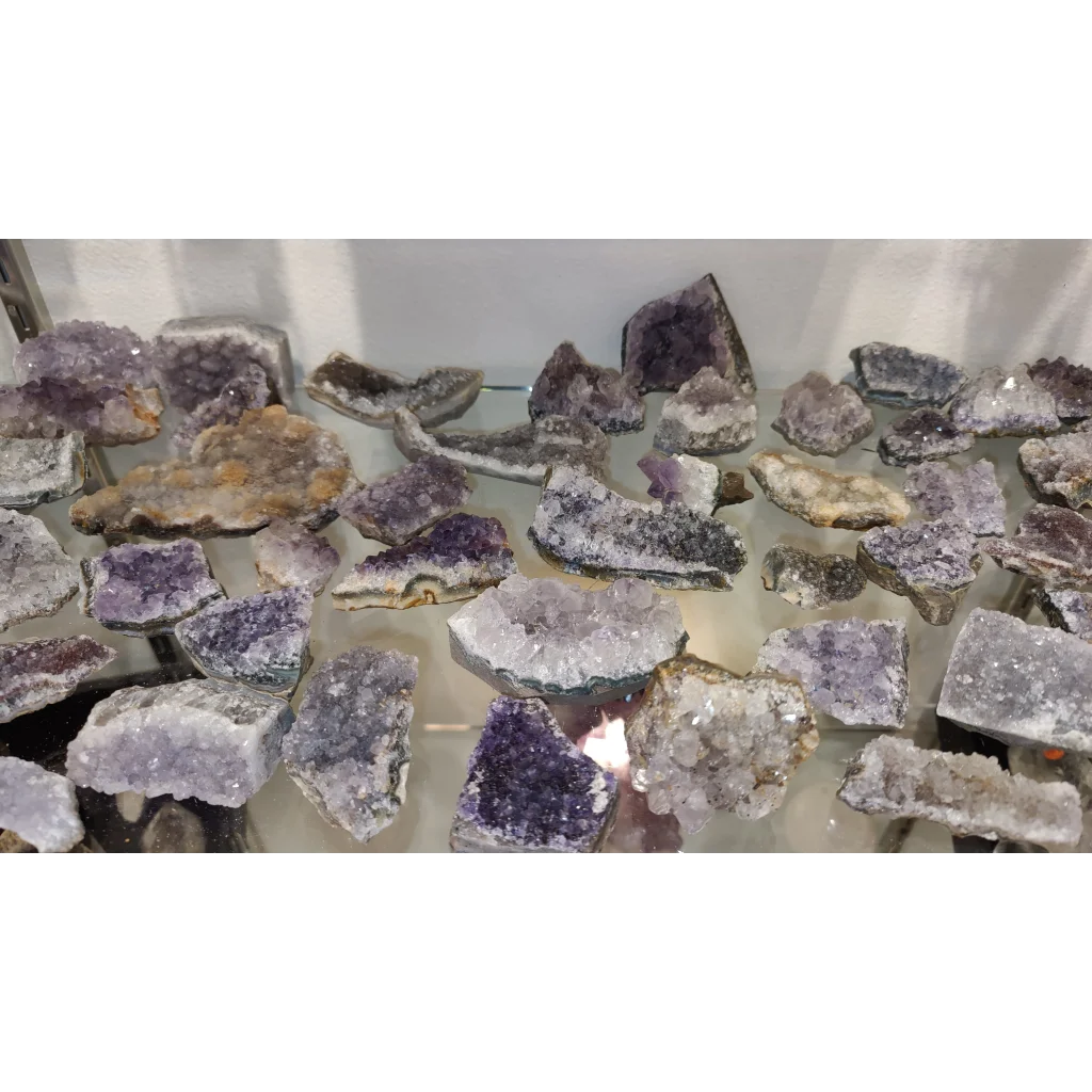 Stunning Brazilian amethyst druze geode with purple crystalline formations on glass