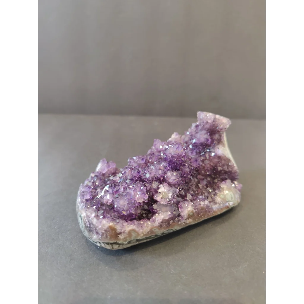 Vibrant Brazilian amethyst geode with sparkling stalactite formations