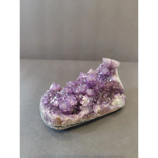 Vibrant Brazilian amethyst geode with sparkling stalactite formations