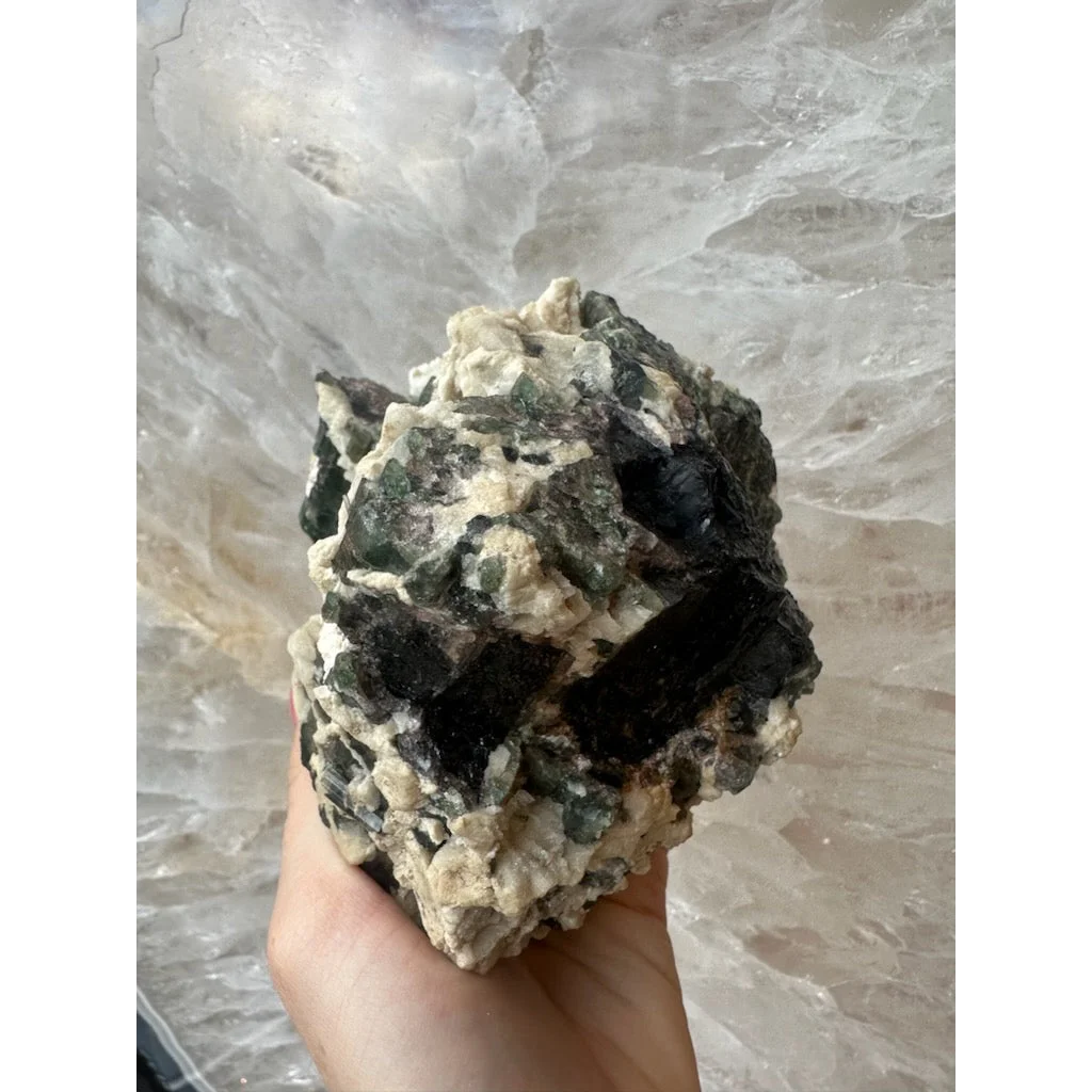 Hand holding stunning Brazilian tourmaline on albite crystal powerhouse