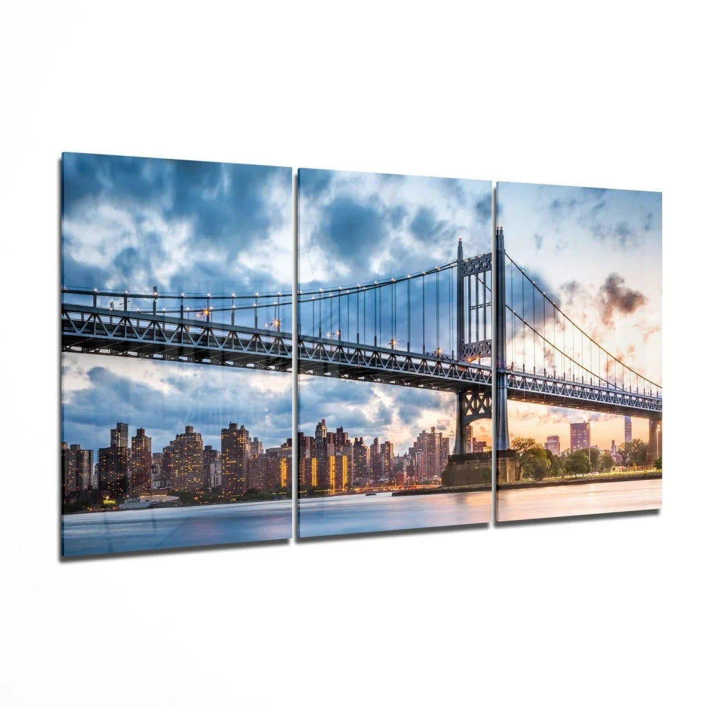 Three-panel canvas wall art of dramatic bridge cityscape under clouds