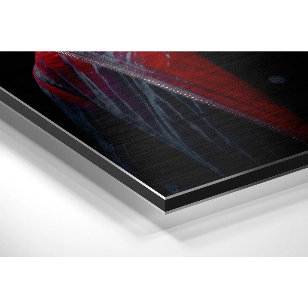 Sleek black and red Apple laptop on brushed aluminium Dibond print