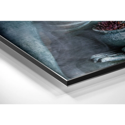 Sleek black acrylic print of moody blue-gray hands and dried flowers on brushed aluminium dibond