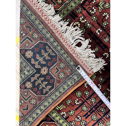 Stunning burgundy Bukharayi rug with intricate Afghani patterns