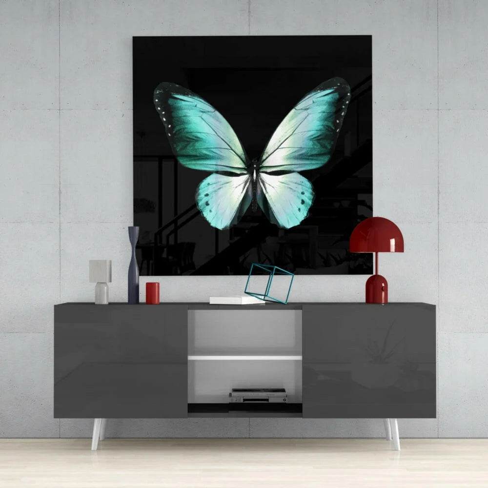Stunning teal butterfly glass wall art with turquoise wings on black background