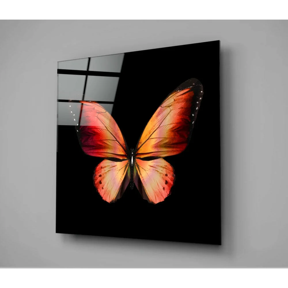Vibrant orange butterfly glass wall art with black background and metallic accents
