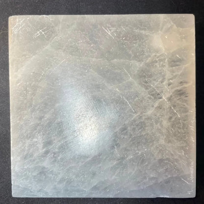 Translucent pale gray selenite slab with crystalline patterns in decorative tray set