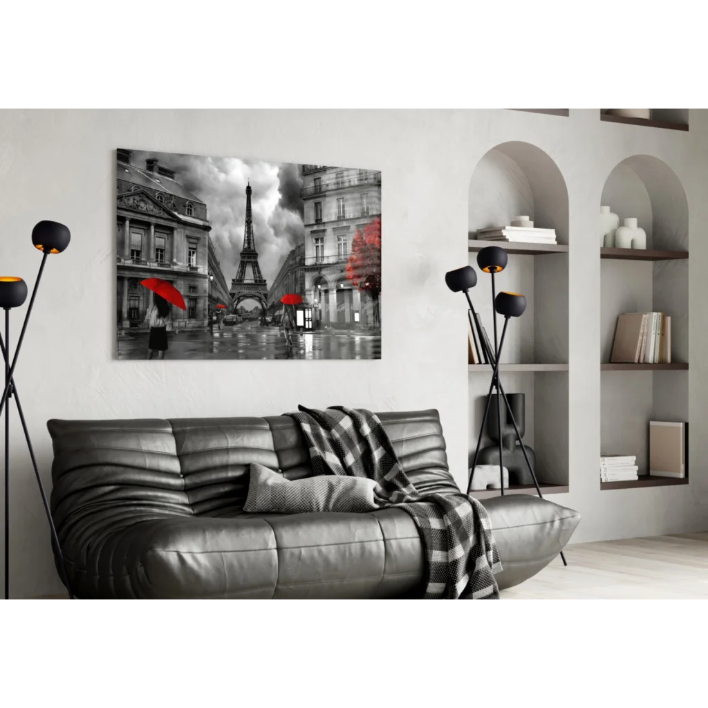 Black leather couch with red plaid throw and Eiffel Tower wall art
