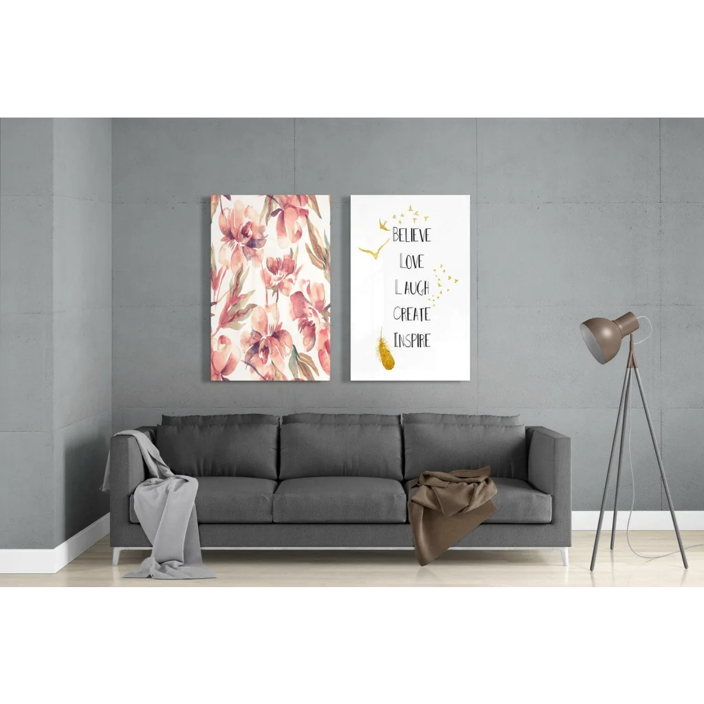 Gray sofa with floral throw and modern tripod lamp near stunning glass wall art