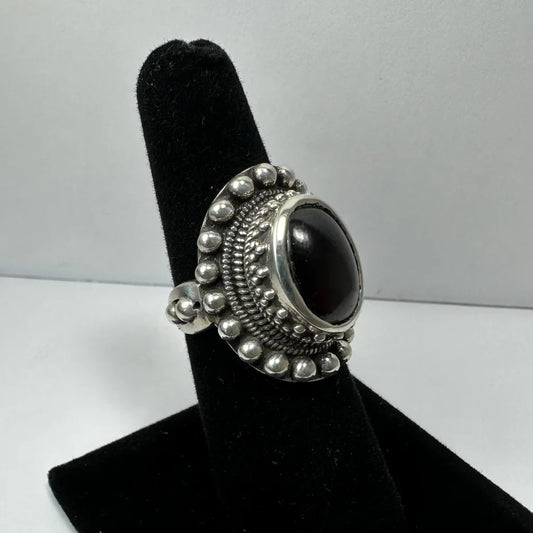 Stunning garnet ring with oval black onyx in ornate silver beaded band