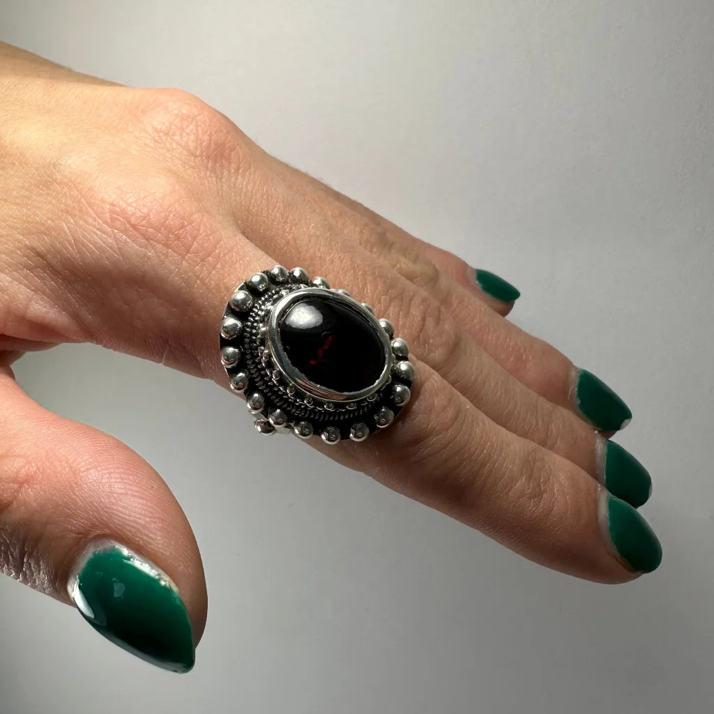 Stunning silver garnet ring with ornate beaded bezel and oval red stone