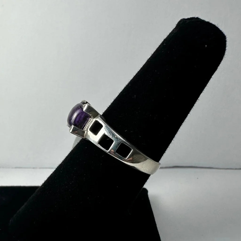 Sleek silver amethyst ring with oval purple stone and geometric cutouts