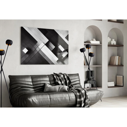 Stunning geometric glass wall art with metallic shine on black leather sofa