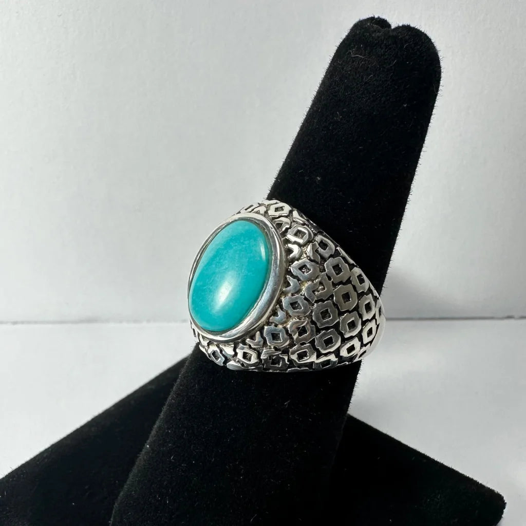 Bold silver turquoise ring with vibrant oval stone in geometric band