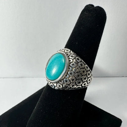 Bold silver turquoise ring with vibrant oval stone in geometric band