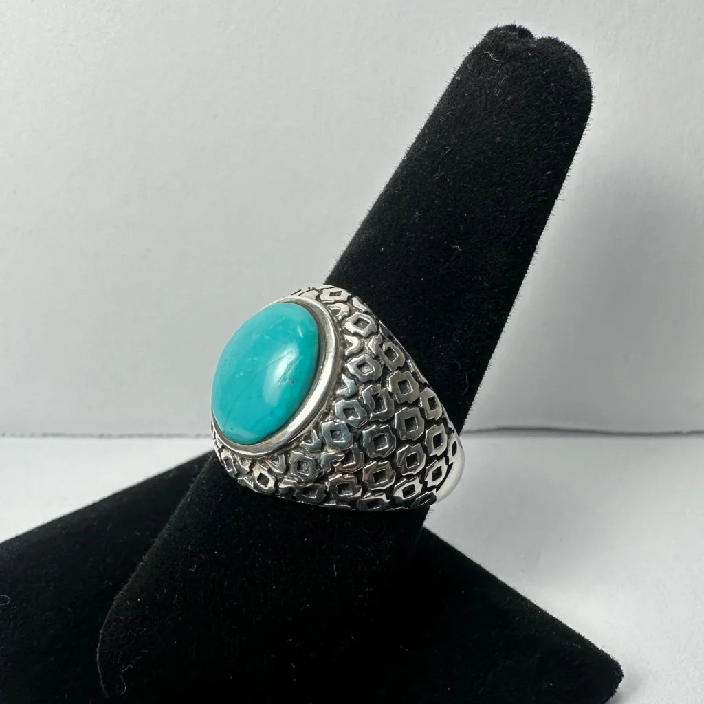 Bold turquoise ring in textured silver with geometric patterns